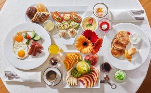 a white tray of breakfast foods on a table at Izmailovo Gamma Hotel in Moscow