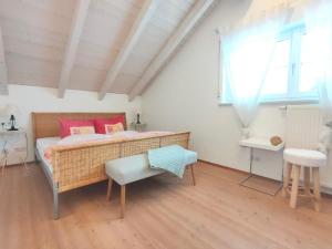 a bedroom with a bed and a table and window at Haus Paradies Superior FEWO`S Loft, Terrasse, private Sauna, aktiv Card, Sankt Englmar in Sankt Englmar +52 photos