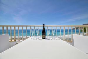 a bottle of wine sitting on a table on the beach at Apartamento Capri - PlusHolidays in Calpe