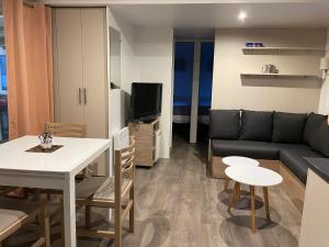 a living room with a couch and a table at Mobil home Domaine de Kerlann in Pont-Aven