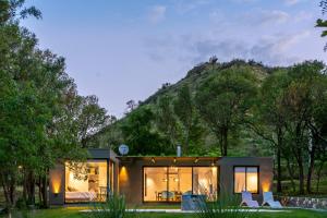 ein kleines Haus mit einem Berg im Hintergrund in der Unterkunft Casa en Potrerillo de Larreta in Alta Gracia