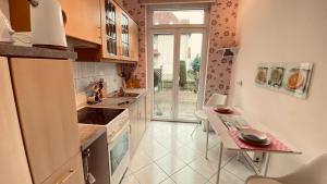 a kitchen with a sink and a table in it at Simply Good Appartment in Borna