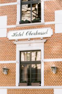 a building with a sign on the side of it at Boutique Hotel Villa Oberkassel in Düsseldorf