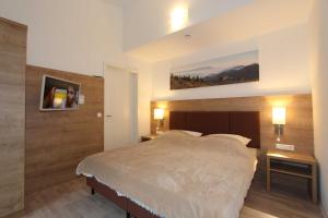 Ein Bett oder Betten in einem Zimmer der Unterkunft H&P Touristik Residenz Grafenmatt GRA-3-2