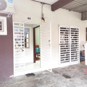 a house being constructed with white doors and windows at Homestay Inap Bakawali Seri Iskandar in Seri Iskandar