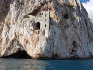 a building built into the side of a rock cliff at Casa Lorenzo&Luca in Gonnesa