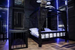 a black room with a bed with a canopy at BDSM Apartament Luxxx gorące serce Częstochowy - ADULTS ONLY in Częstochowa