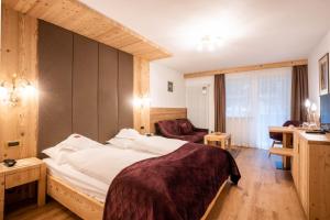 Postel nebo postele na pokoji v ubytování Hotel Gran Paradis