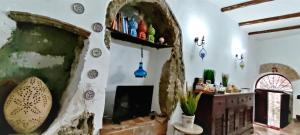 a living room with a fireplace and a shelf at Country House Marta in Marta