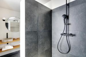 a bathroom with a shower and a mirror at Amazing apartments - Arc de Triomphe-Champs Elysée in Paris +18 photos