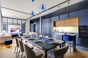 a dining room and kitchen with a table and chairs at Amazing apartments - Arc de Triomphe-Champs Elysée in Paris