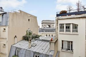 a view of the roofs of two buildings at Amazing apartments - Arc de Triomphe-Champs Elysée in Paris