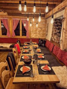 a long dining room with a long table with food on it at Chalet Sepp in Belalp