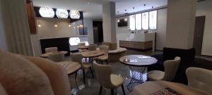 a restaurant with tables and chairs in a room at Acar Airport Hotel Plus in Arnavutköy
