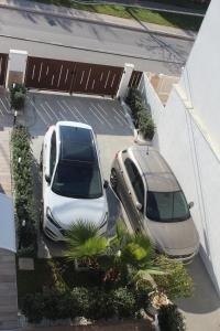 two cars parked next to each other in a parking lot at Le casette in Monopoli