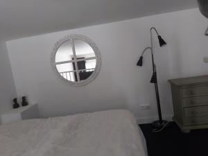 1 dormitorio con cama y espejo en la pared en Stadslogement 8 en Zwolle