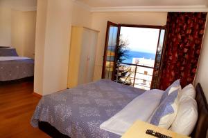 A bed or beds in a room at Miletus Otel Şile