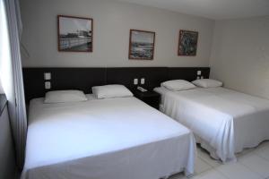 Postel nebo postele na pokoji v ubytování Absolutte Hotel