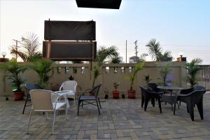 a patio with chairs and a table and a piano at Manomay Homes in Nagpur