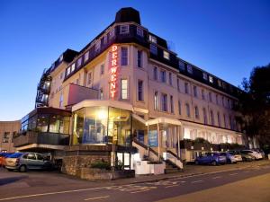 a building with a neon sign on the side of it at TLH Derwent Hotel - TLH Leisure, Entertainment and Spa Resort in Torquay