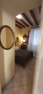 um quarto com uma cama e um espelho na parede em Ca' del Forner em Veneza