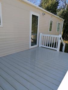 a deck in front of a house at Yare Village, Breydon water holiday park in Great Yarmouth