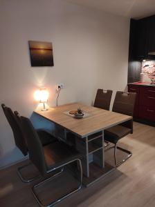 a dining room table with chairs and a light on it at Friesenstube in Schweiburg