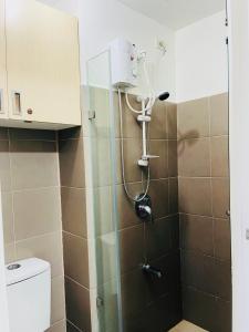 a shower in a bathroom with a toilet at Wind Suites Tagaytay at SMDC in Tagaytay