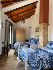 Ліжко або ліжка в номері Casa Asador Sierra De Aracena
