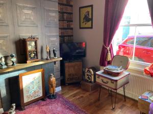 a living room with a table and a tv at Bedford House Retreat in Scarborough