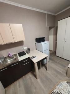 a small kitchen with a table and a sink at Гостевой дом на Цюрупы 32,Г2 in Sochi