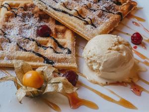 a plate of waffles with a scoop of ice cream at Boris Godunov Hotel in Moscow