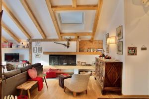a living room with a couch and a table at Beautiful design 3 bedroom apartment in Cortina in Cortina dʼAmpezzo