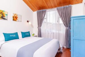 Ένα ή περισσότερα κρεβάτια σε δωμάτιο στο Ayenda Casa La Castellana