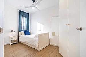 een witte slaapkamer met een bed en een raam bij Dubamar apartments in Aguadulce
