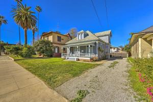 a house with a palm tree in the yard at Riverside House with Yard about 1 Mi to Downtown! in Riverside