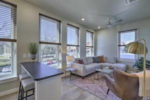 a living room with a couch and a table at Stylish San Marcos Apt in the Heart of Dwtn! in San Marcos