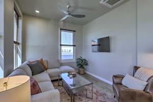 a living room with a couch and a tv at Stylish San Marcos Apt in the Heart of Dwtn! in San Marcos