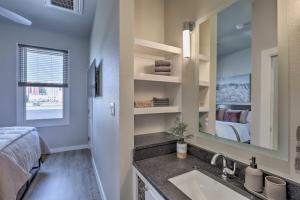a bathroom with a sink and a bedroom at Stylish San Marcos Apt in the Heart of Dwtn! in San Marcos +21 photos