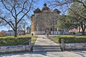 a building with a fence in front of it at Stylish San Marcos Apt in the Heart of Dwtn! in San Marcos