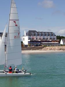 two people on a sail boat in the water at Les Rochers in Carnac