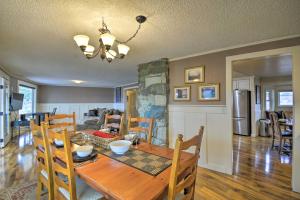 a dining room and living room with a wooden table at Breathtaking Port Ludlow Home with Deck and Yard in Port Ludlow
