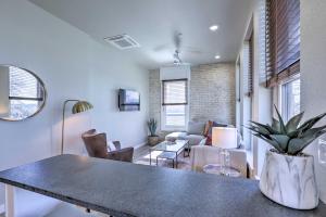 a living room with a table and a couch at Sleek, Newly Updated Downtown San Marcos Apt! in San Marcos