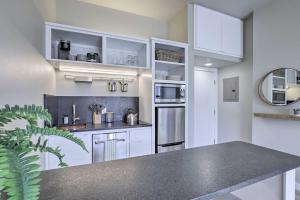 a kitchen with white cabinets and a counter top at Inviting San Marcos Apartment with Washer and Dryer in San Marcos
