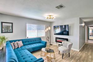 a living room with a blue couch and a table at Charming Phoenix Home with Patio about 3 Miles to Dtwn! in Phoenix