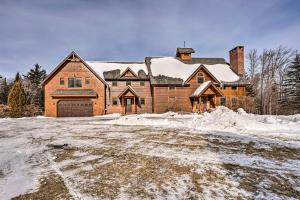 a large brick house with snow on the ground at Secluded Vermont Retreat Outdoor Pool and Deck in Stratton