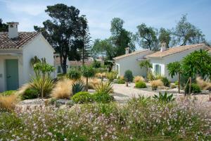 a garden in front of two houses at Boho Club in Marbella