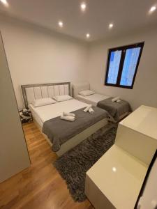 a bedroom with two beds and a window at Days Inn Apartments in Ulcinj