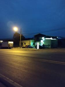 a building with a street light next to a road at Pousada Shalom in Barracão