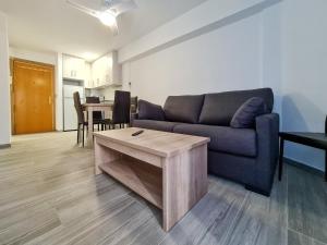 a living room with a couch and a table at Apartamento Narcea in Benidorm +31 photos